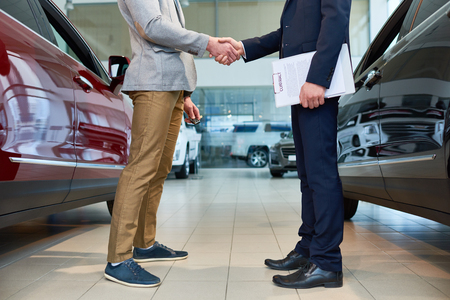 People Shaking Hands in Car Showroomの写真素材