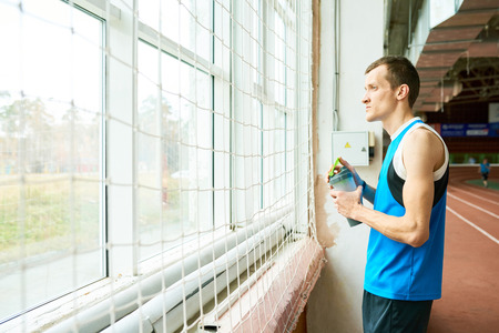 Pensive Sportsman by Window