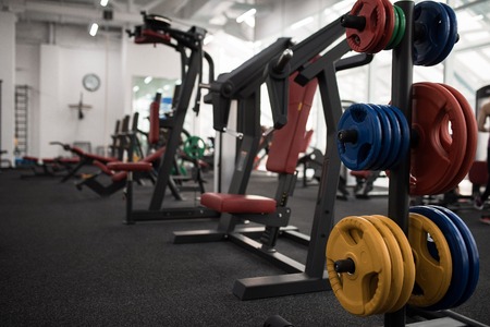 Background image of exercise machines for weight training in empty modern gym, copy spaceの写真素材