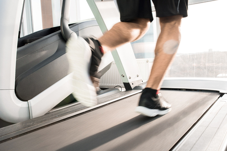 Unrecognizable Man Running on Treadmill