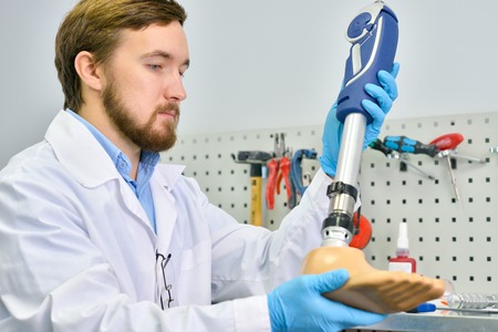 Young Prosthetist Holding  Artificial Leg
