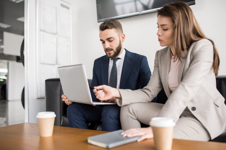Successful Business Couple Working with Laptopの写真素材
