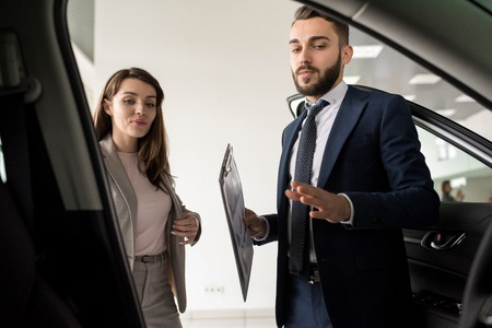 Handsome Man Presenting Luxury Carの写真素材