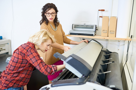 Women Setting Up Plotterの写真素材