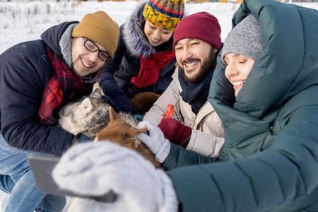 Friends Taking Selfie in Winterの写真素材