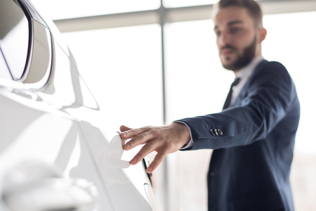 Businessman Loving Expensive Carsの写真素材