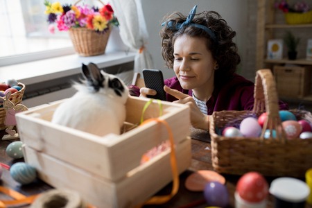 Woman Photographing Easter Decorationsの写真素材