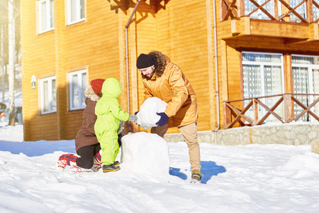 Family building snowman