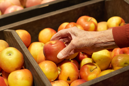 Hand Taking Apples in Supermarketの写真素材