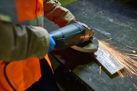 Man Working with Metal at Factory