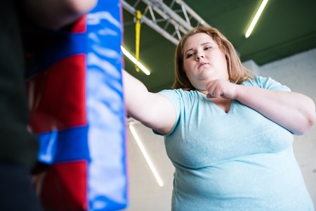 Strong Obese Woman Boxing in Gymの写真素材