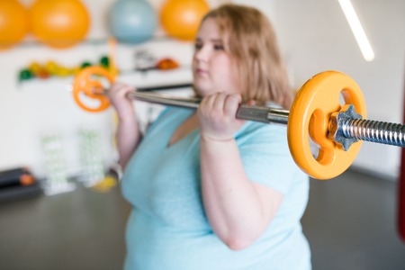 Obese Woman Working Out with Barbellの写真素材