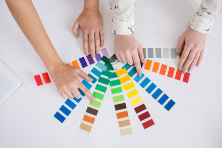 Close-up shot of unrecognizable interior designers using color palettes while choosing necessary paint for new projectの写真素材