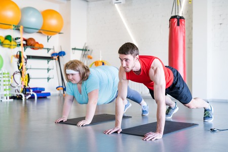 Obese Woman Working Out in Fitness Club