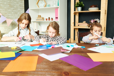 Little Sisters Wrapped up in Handicraftの写真素材