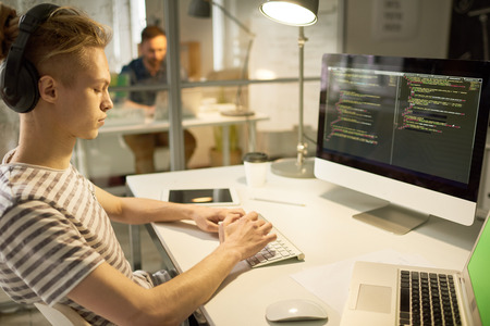 Confident software writer busy with new program