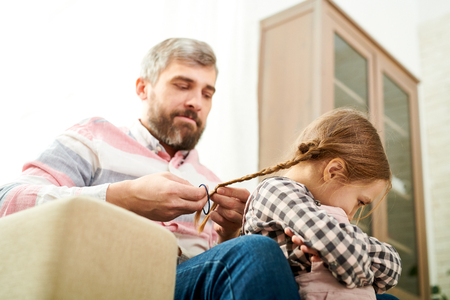 Bearded Father Braiding Little Daughterの写真素材