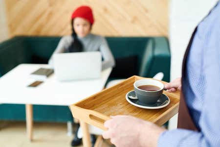 Waiter Bringing Coffee in Cafeの写真素材