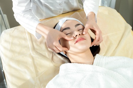Asian Woman Enjoying Face Massageの写真素材