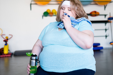 Tired Overweight Woman in Gymの写真素材
