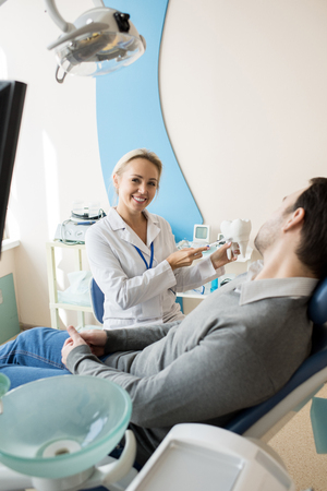 Female Dentist Working in Modern Clinicの写真素材
