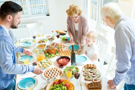 Happy Family Setting Table for Dinnerの写真素材