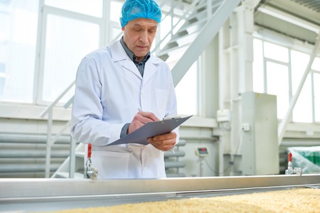 Senior Worker Overseeing Food Production