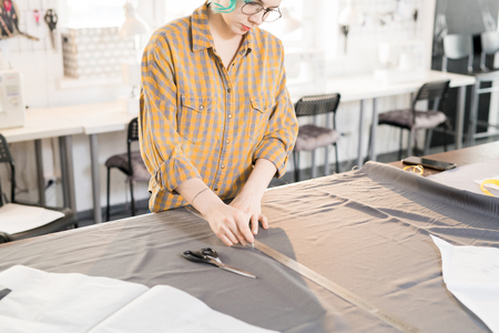 Contemporary Fashion Designer Tracing Fabric
