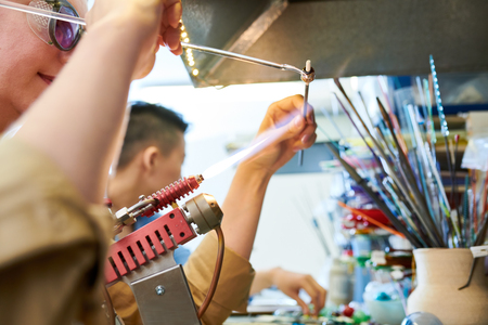 Female Artist Shaping Glass Bead Burnerの写真素材