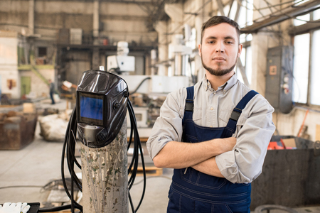 Purposeful handsome welder in factory workshopの写真素材