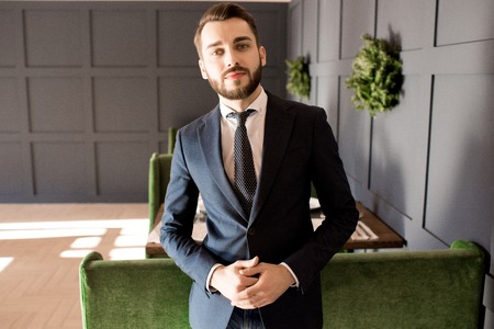 Serious successful businessman in lobby