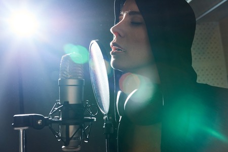 Amazing girl singing in back litの写真素材