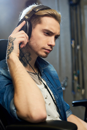 Stylish composer listening to music in studioの写真素材
