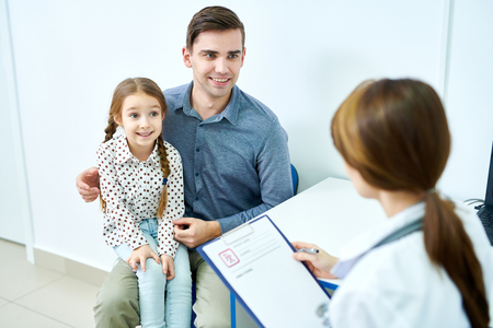 Father and daughter at doctor appointmentの写真素材