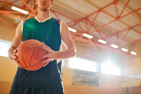 Crop man on basketball court