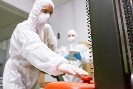 Factory worker pushing buttonの写真素材