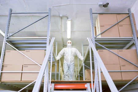 Storage employee standing in protective clothingの写真素材