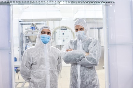 Two factory workers standing in protective clothesの写真素材