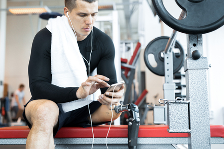 Adaptive Athlete Resting in Gymの写真素材