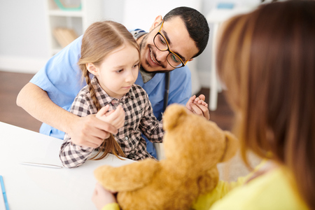 Playful  Pediatrician Working with Little Girlの写真素材