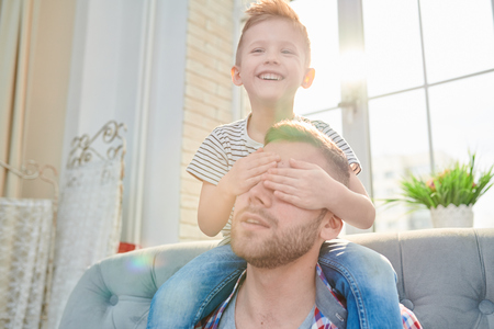Cute Little Boy Sitting on Dads Shouldersの写真素材