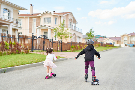 Children Riding in Streetの写真素材