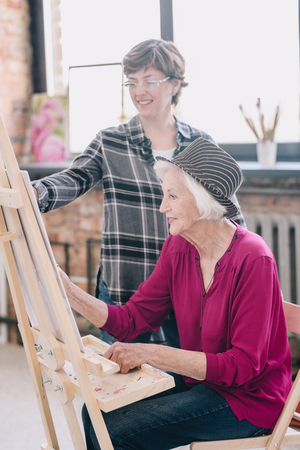 Cheerful Senior Woman in Art Classの写真素材