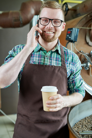 Modern Barista Speaking by Phoneの写真素材