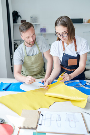 People working with leather fabricの写真素材