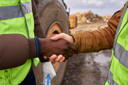 Workers Shaking Hands Outdoors Closeup