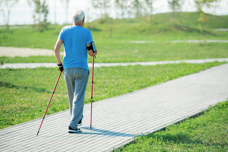 Senior Man Practicing Nordic Walking Back Viewの写真素材