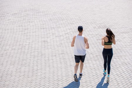 Couple Jogging in City Backgroundの写真素材