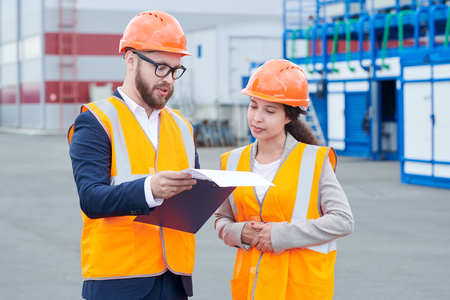Two Workers Discussing Project Outdoors