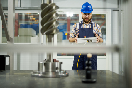 Factory Worker Operating Machines